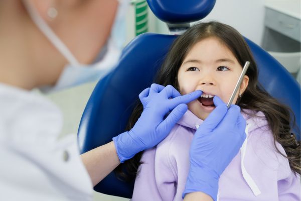 Dentist Checking for Milk Tooth