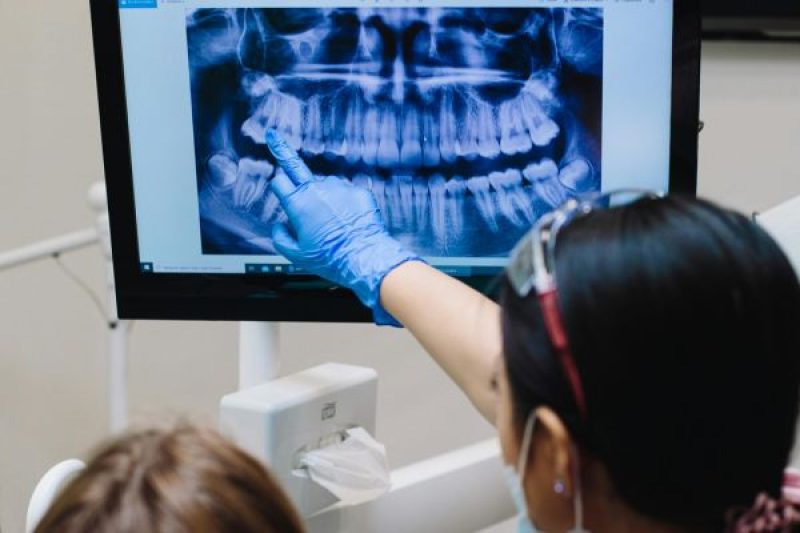 Pediatric Dentist with Dental X-Ray Image