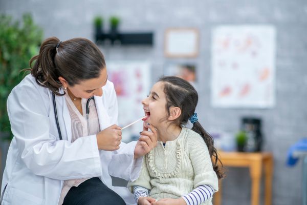 Pediatric Dentist doing a Routine Checkup