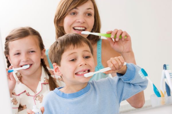Kids Brushing their Teeth with Mom